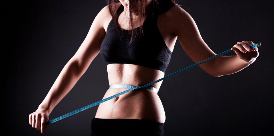 Growth Supplements - IMAGEM ILUSTRATIVA DE UMA MULHER COM UMA FITA MÉTRICA NA BARRIGA
